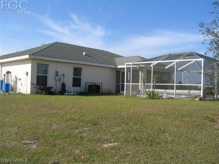 3618 20th Street Southwest Lehigh Acres, FL 33976 - Photo 11 of 12 a view of a house with backyard and garden