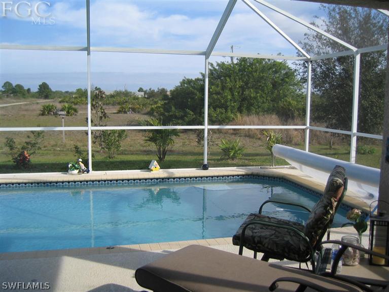 3618 20th Street Southwest Lehigh Acres, FL 33976 - Photo 2 of 12 a view of a chair and tables in the balcony