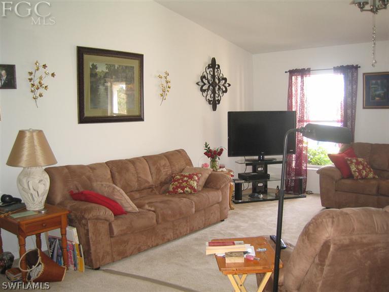3618 20th Street Southwest Lehigh Acres, FL 33976 - Photo 5 of 12 a living room with furniture and a flat screen tv