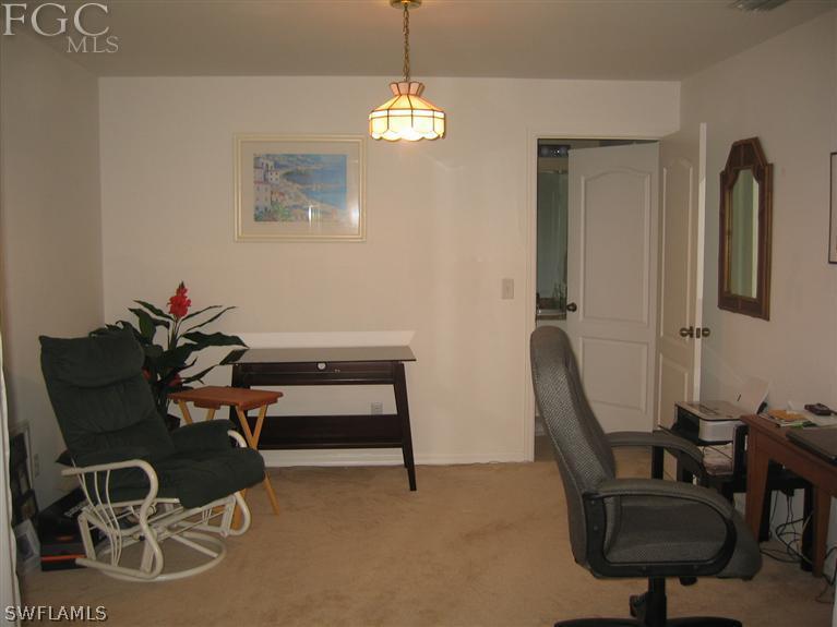 3618 20th Street Southwest Lehigh Acres, FL 33976 - Photo 8 of 12 a view of a workspace with furniture and a window