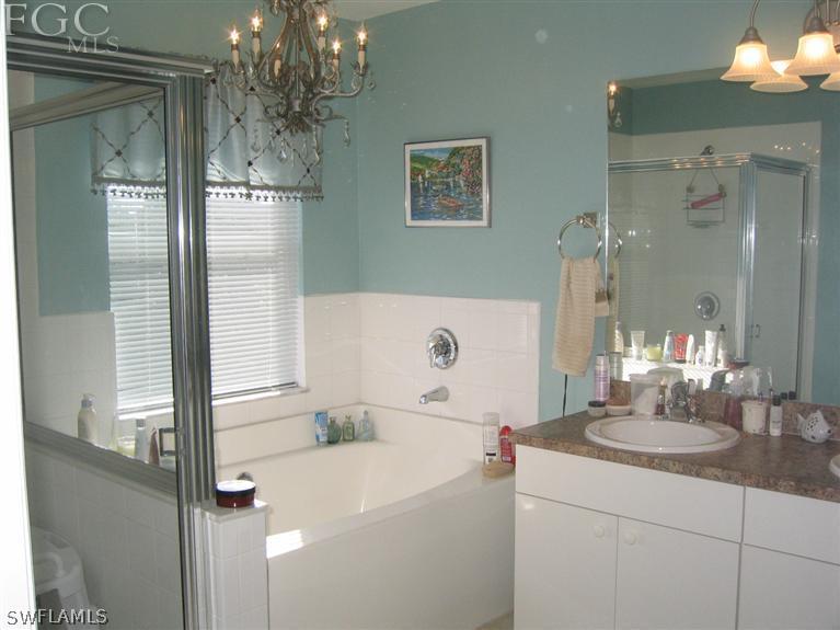 3618 20th Street Southwest Lehigh Acres, FL 33976 - Photo 10 of 12 a bathroom with a sink and a mirror