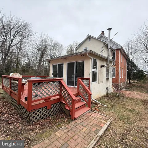 a view of a house with wooden fence