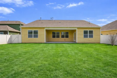 a view of a house with a backyard