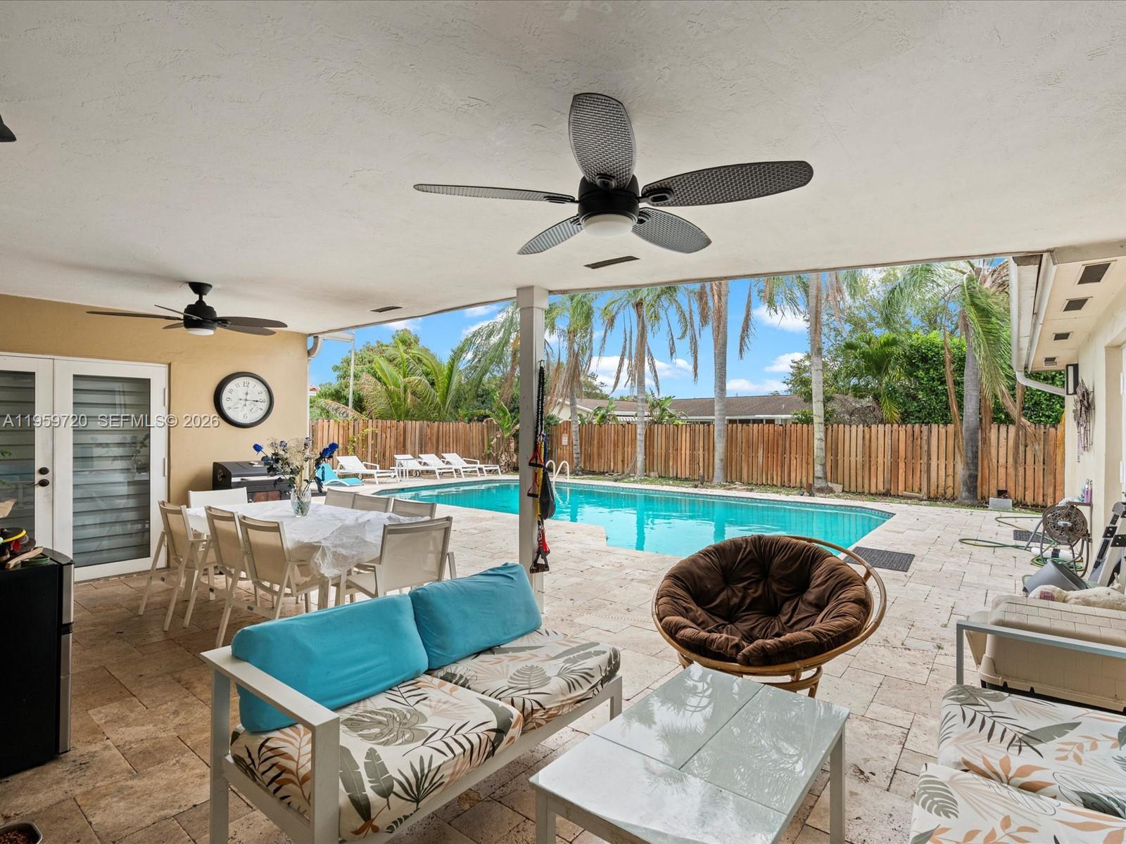 1113 North 46th Terrace Hollywood, FL 33021 - Photo 11 of 41 a living room with furniture and a floor to ceiling window