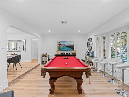 a living room with furniture a table and a large window