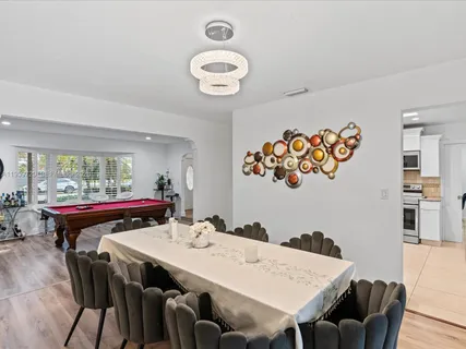 a view of a dining room with furniture and a large window