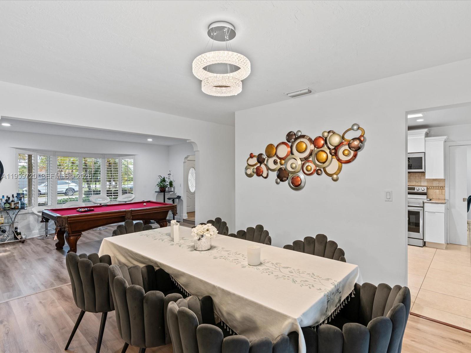 1113 North 46th Terrace Hollywood, FL 33021 - Photo 19 of 41 a view of a dining room with furniture and a large window