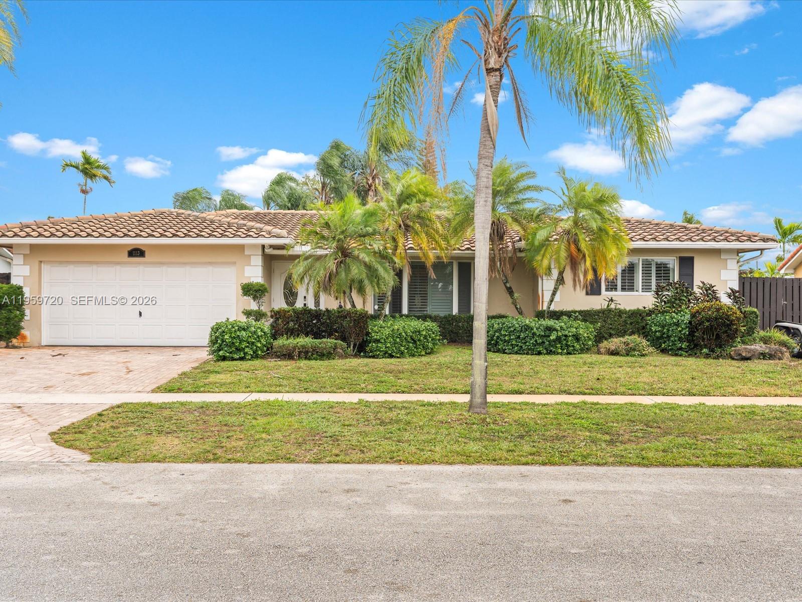 1113 North 46th Terrace Hollywood, FL 33021 - Photo 2 of 41 a view of a house with a yard and potted plants