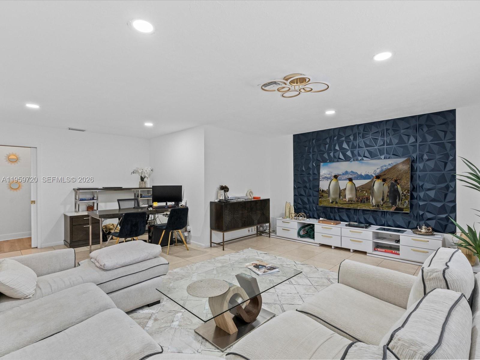 1113 North 46th Terrace Hollywood, FL 33021 - Photo 24 of 41 a living room with furniture and a flat screen tv