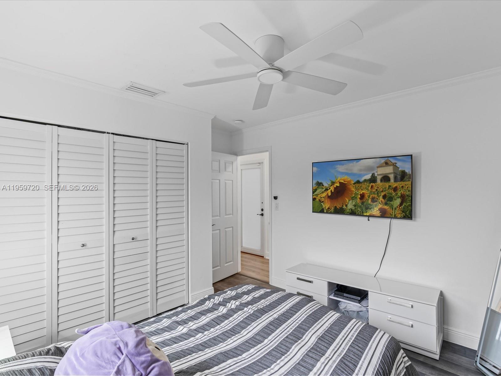 1113 North 46th Terrace Hollywood, FL 33021 - Photo 32 of 41 a bedroom with a bed and a chandelier