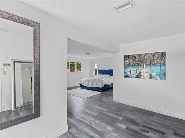 a bedroom with a bed and a painting on the wall