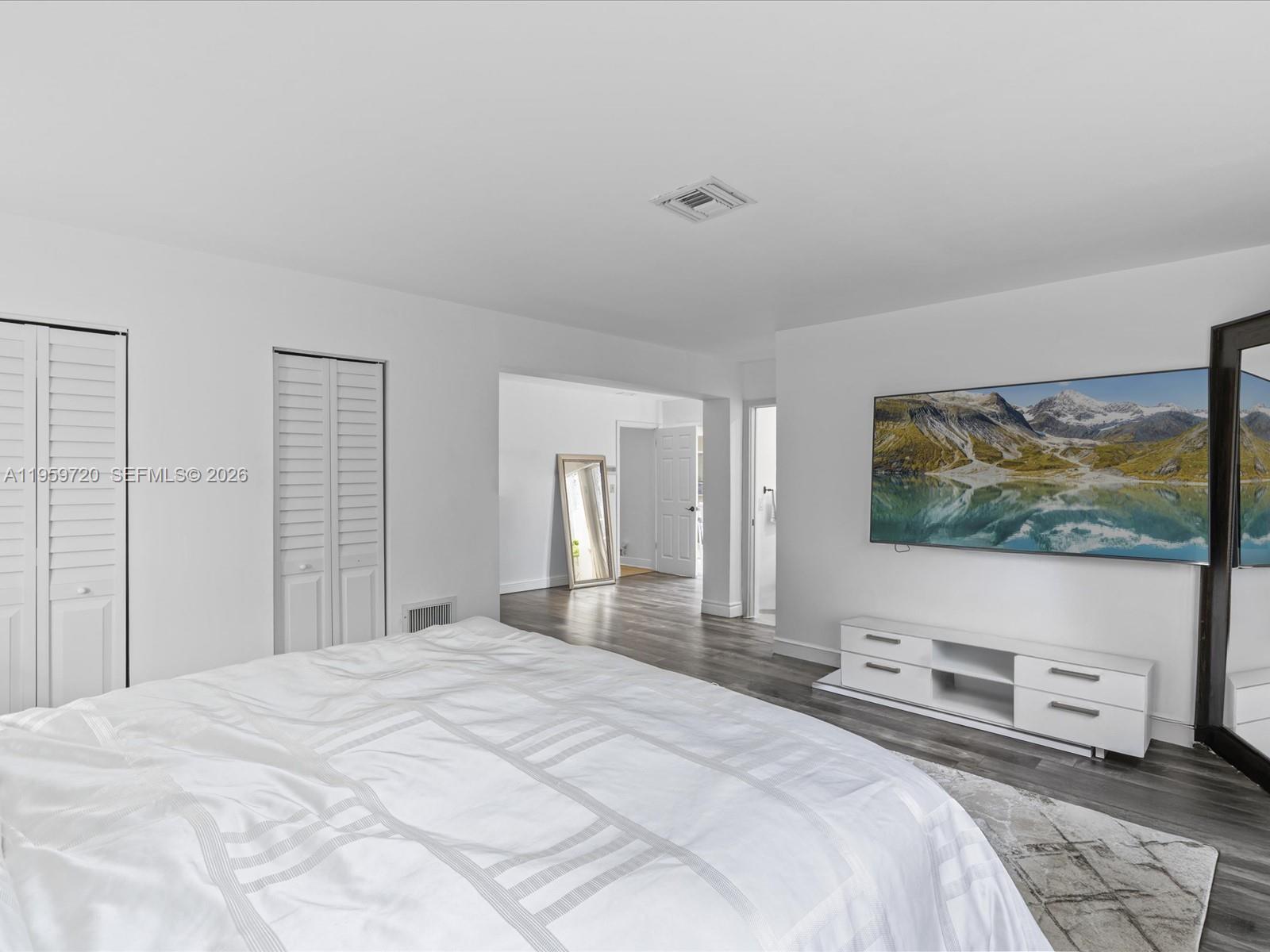 1113 North 46th Terrace Hollywood, FL 33021 - Photo 35 of 41 a bedroom with a bed and a flat screen tv