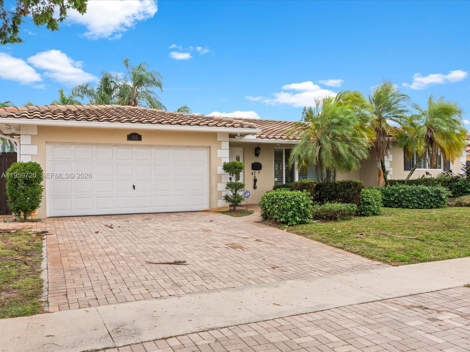 1113 North 46th Terrace Hollywood, FL 33021 - Photo 4 of 41 front view of a house with a yard