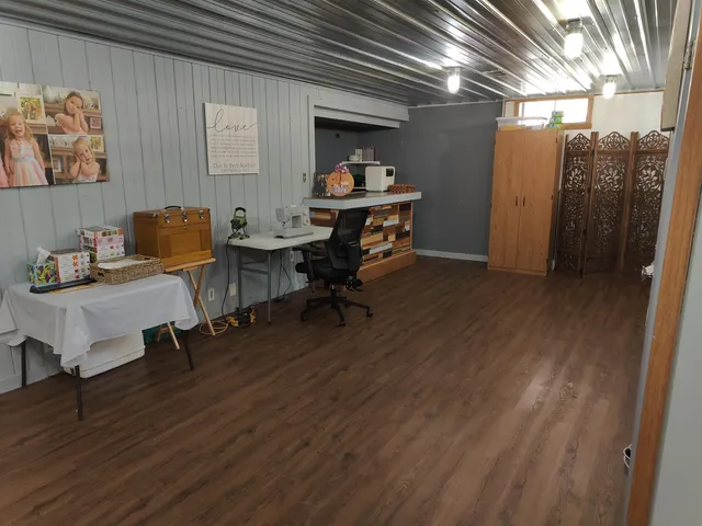 a workspace with wooden floor and furniture