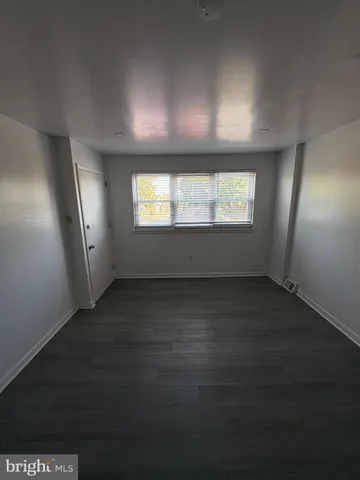 a view of an empty room and wooden floor