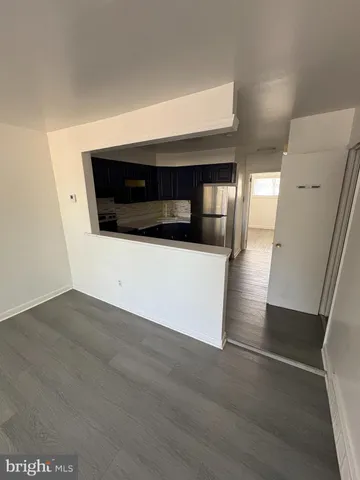 a kitchen with stainless steel appliances a refrigerator a stove a microwave and a refrigerator