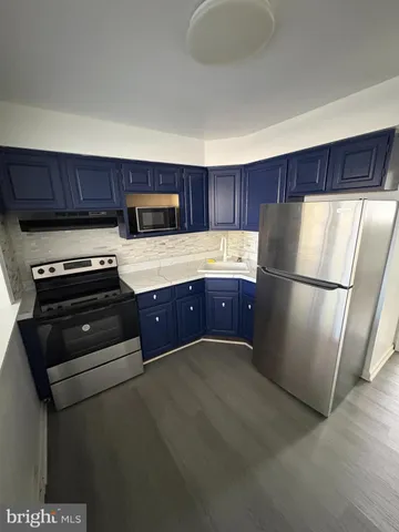 a kitchen with wooden cabinets and a stove top oven