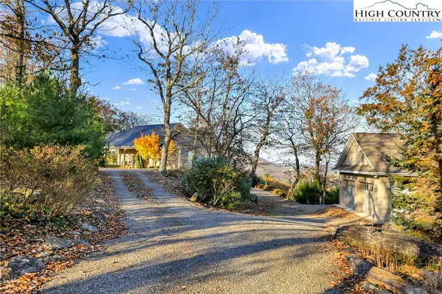a view of a house with a yard and pathway