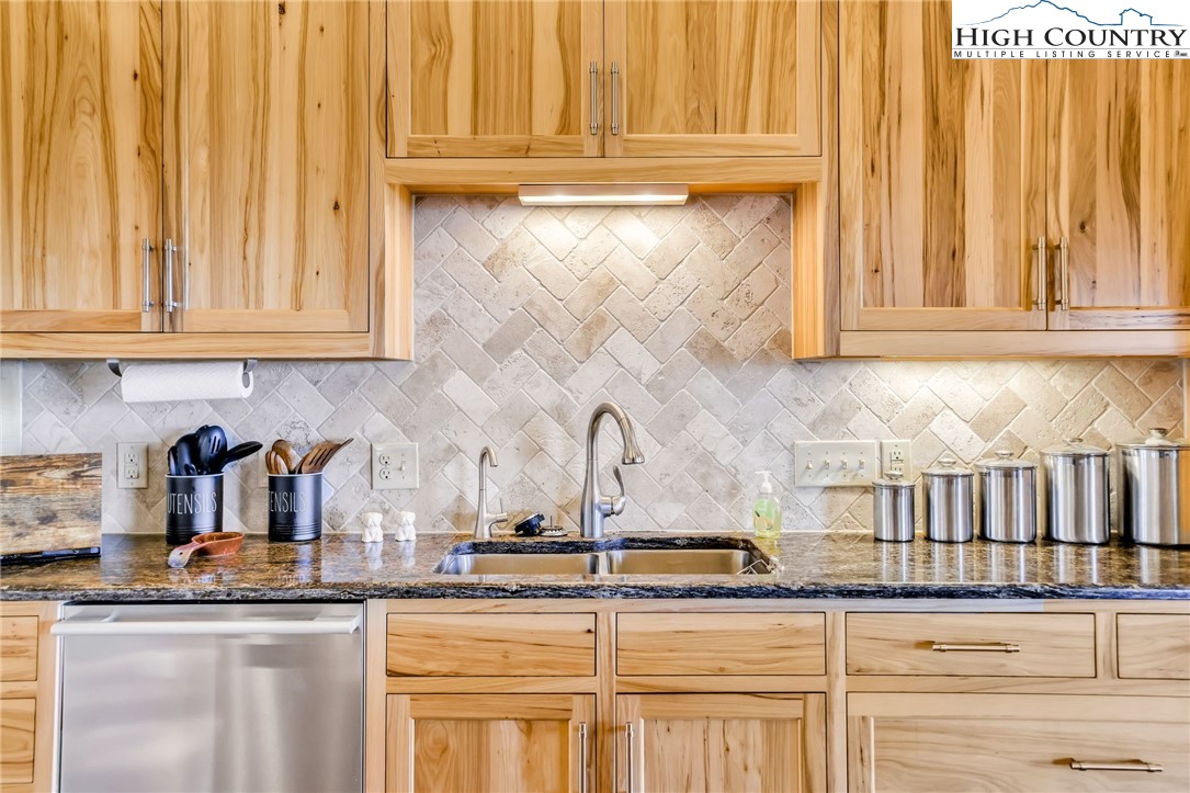 324 Rocky Ridge Lane Glade Valley, NC 28627 - Photo 19 of 43 a kitchen with granite countertop white cabinets and sink