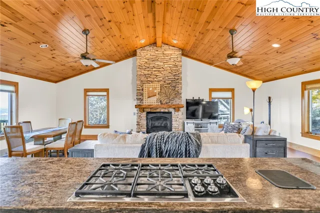 a kitchen with stainless steel appliances granite countertop a sink and a refrigerator