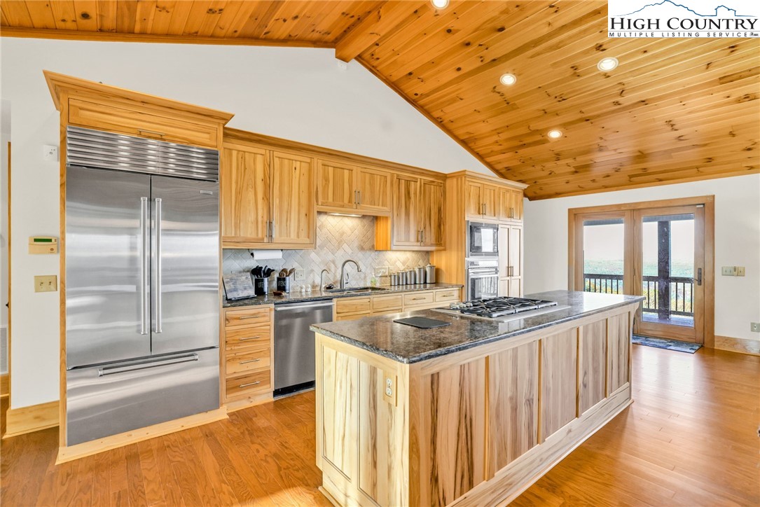 324 Rocky Ridge Lane Glade Valley, NC 28627 - Photo 25 of 43 a kitchen with stainless steel appliances granite countertop a sink and a refrigerator