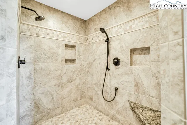 a spacious bathroom with a granite countertop toilet sink and mirror