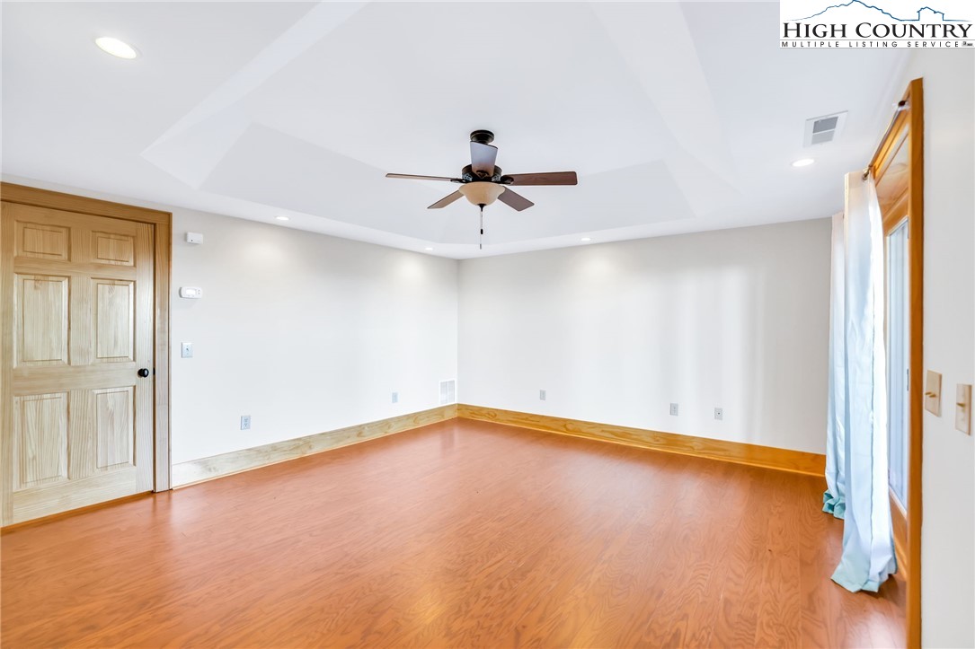 324 Rocky Ridge Lane Glade Valley, NC 28627 - Photo 34 of 43 wooden floor in an empty room with a window