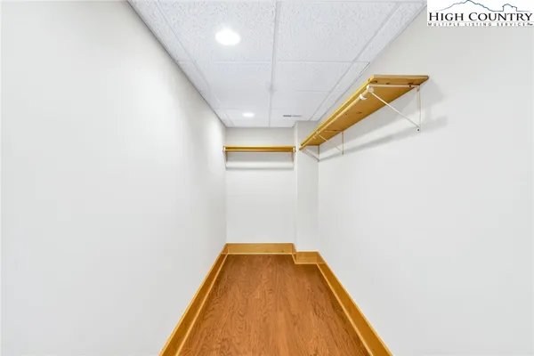a bathroom with a granite countertop sink a mirror and a shower
