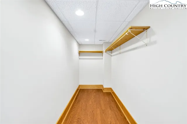 a bathroom with a granite countertop sink a mirror and a shower