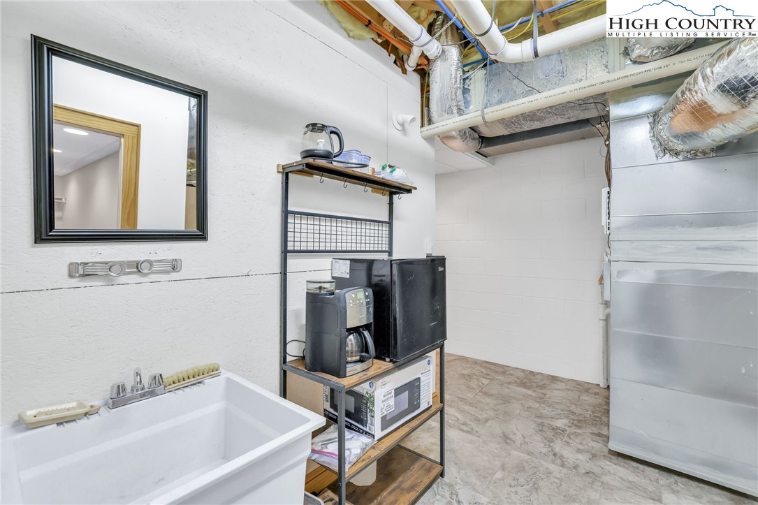 324 Rocky Ridge Lane Glade Valley, NC 28627 - Photo 39 of 43 a bathroom with a bathtub and a sink