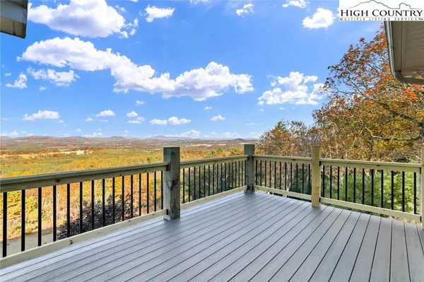 a view of a balcony with wooden floor