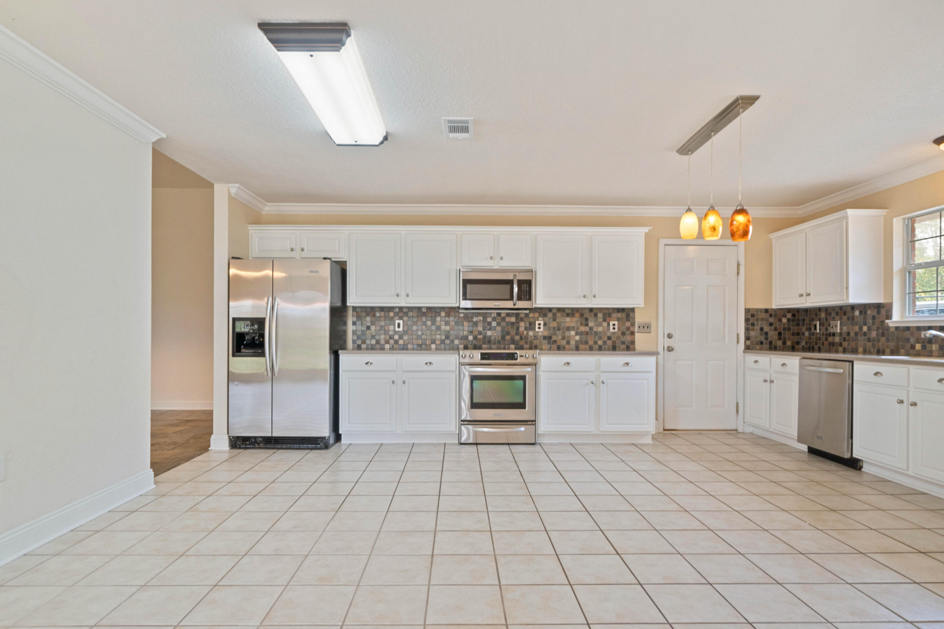 414 Driftwood Point Road Santa Rosa Beach, FL 32459 - Photo 11 of 36 a large white kitchen with cabinets a washer and dryer