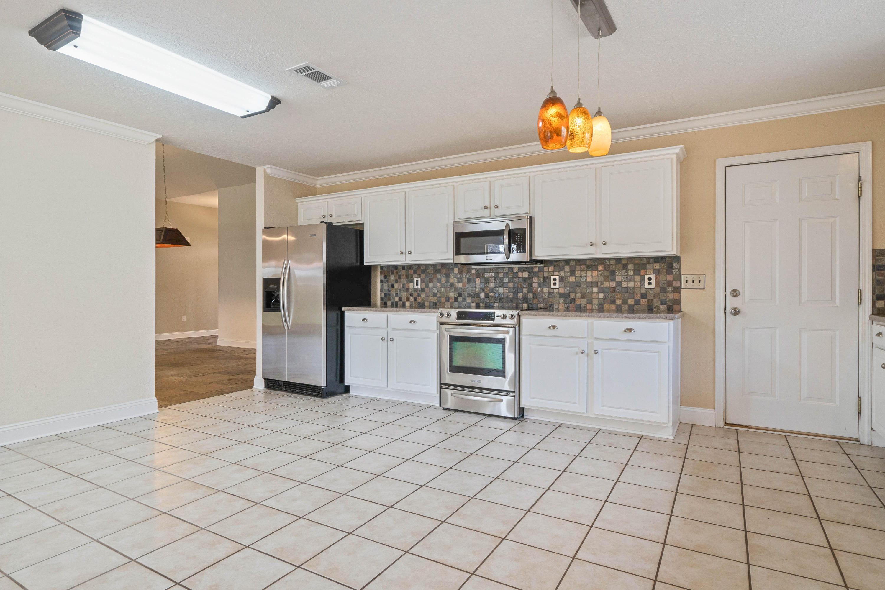 414 Driftwood Point Road Santa Rosa Beach, FL 32459 - Photo 13 of 36 a kitchen with stainless steel appliances a refrigerator sink and cabinets