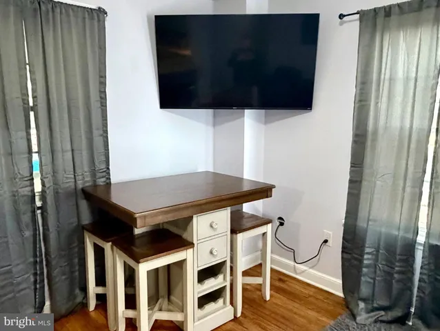 a living room with a flat screen tv and outdoor view