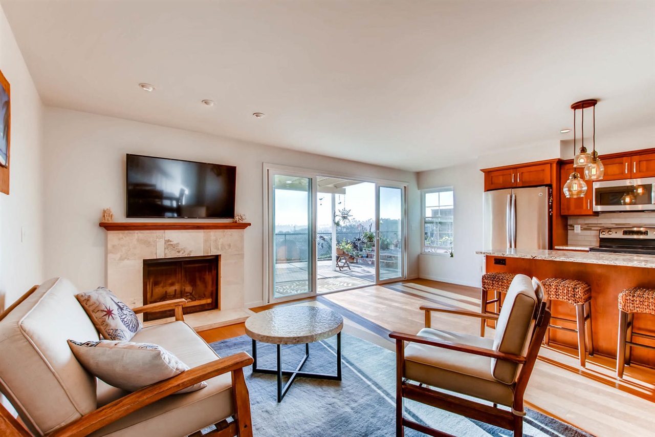2939 Lancaster Road Carlsbad, CA 92010 - Photo 4 of 14 Living room with fireplace and view through 11 foot glass doors that open to outdoor living space