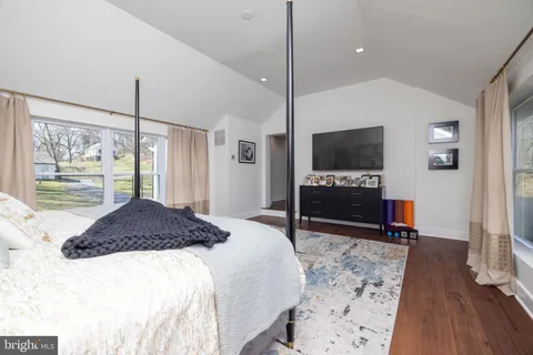 a bedroom with a bed and a table in it