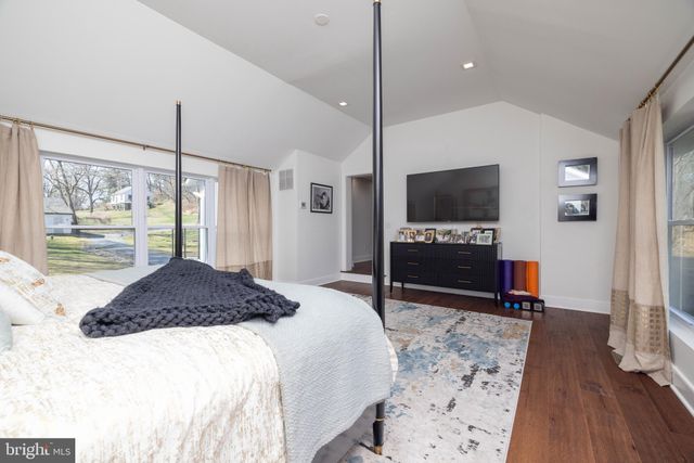 a bedroom with a bed and a table in it