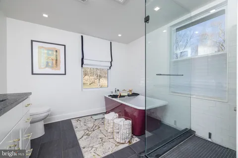 a view of a house with a big yard and large trees