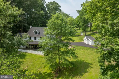 a front view of a house with a yard and potted plants