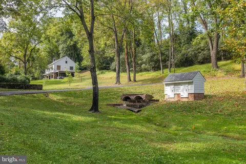 a view of a hallway with wooden floor and furniture