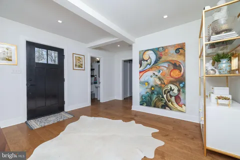 a living room with furniture pool table and a fireplace