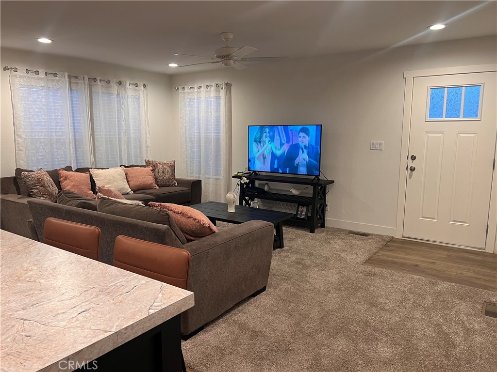 3444 West Center Street, Unit 43 Riverside, CA 92501 - Photo 4 of 16 a living room with furniture and a flat screen tv