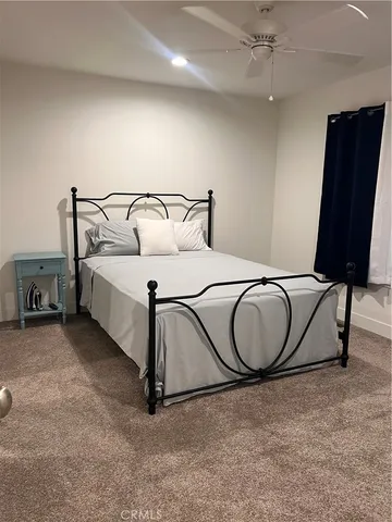 a bedroom with a bed and dresser