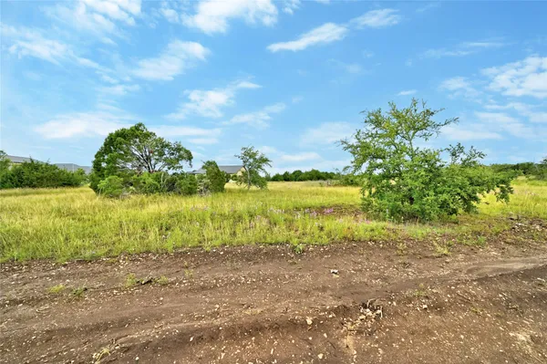a view of a lake view with houses in the back