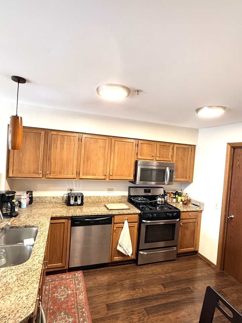 1159 East Addison Avenue Lombard, IL 60148 - Photo 2 of 14 a kitchen with a stove a sink and a refrigerator
