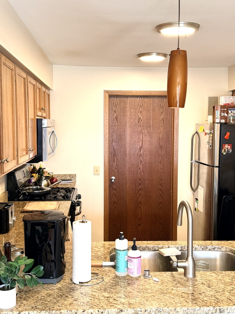 1159 East Addison Avenue Lombard, IL 60148 - Photo 3 of 14 a kitchen with a stove and a sink