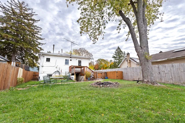 a view of a house with backyard and sitting area