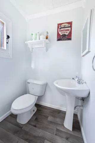 a white toilet sitting next to a bathroom sink