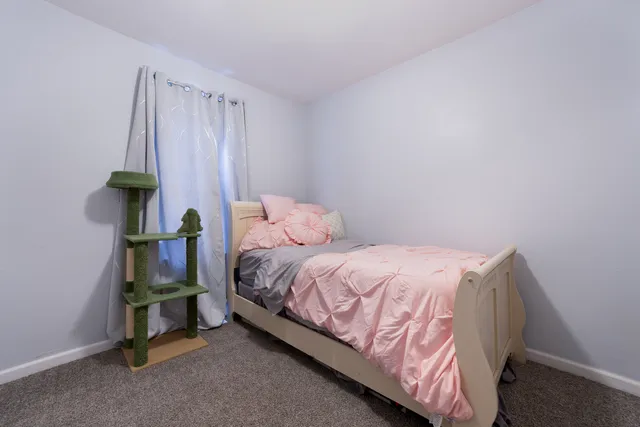 a bedroom with a bed and a window