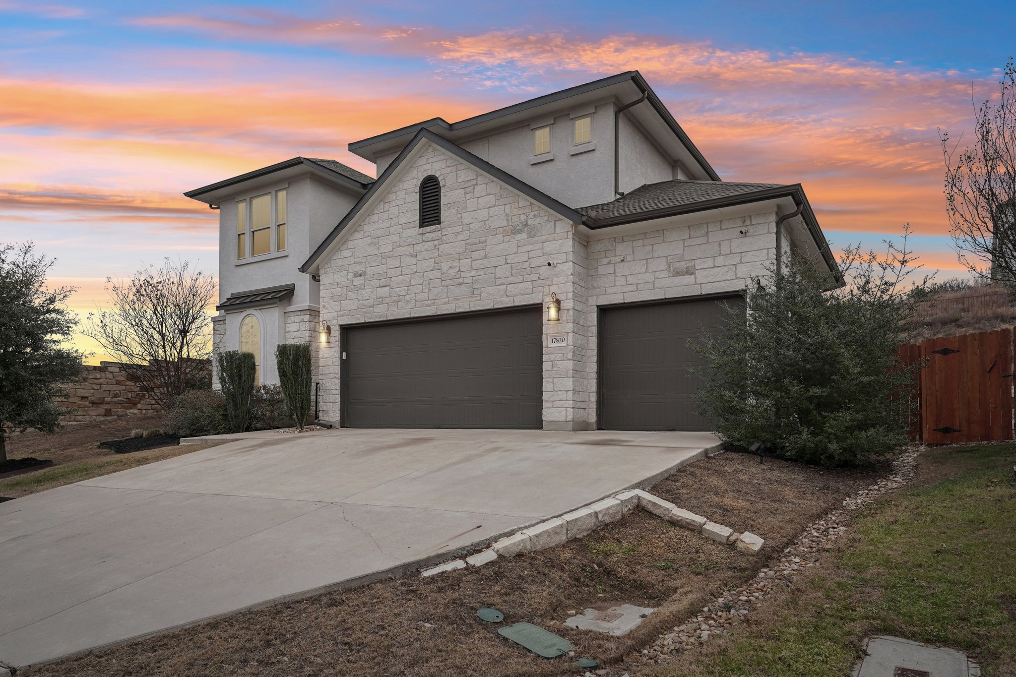 17820 Limestone Spring Lane Austin, TX 78738 - Photo 20 of 35 a front view of a house with a yard and garage